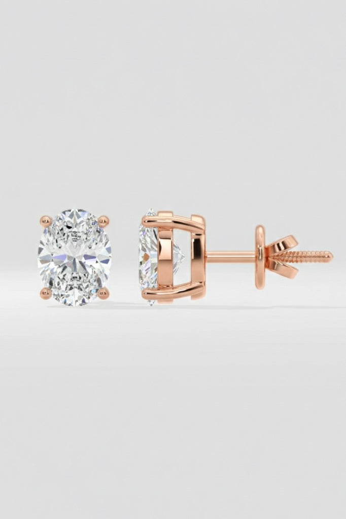 Rose gold diamond stud earrings on a light gray background