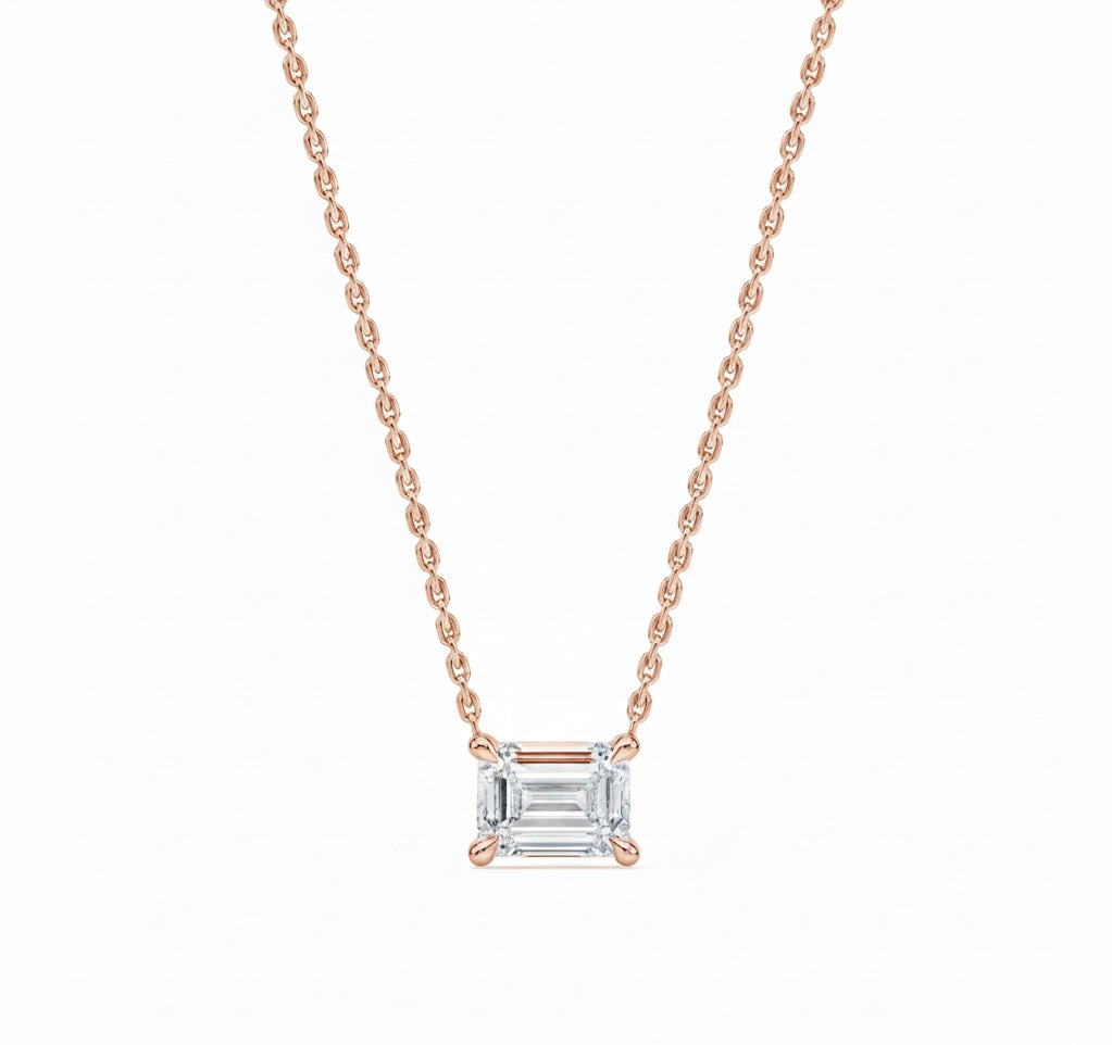 Rose gold necklace with a diamond pendant on a white background