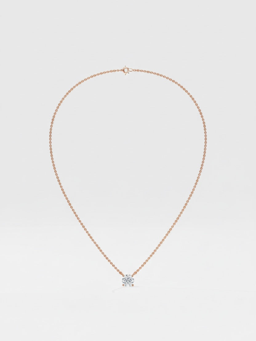 Rose Gold necklace with a round diamond pendant on a light gray background