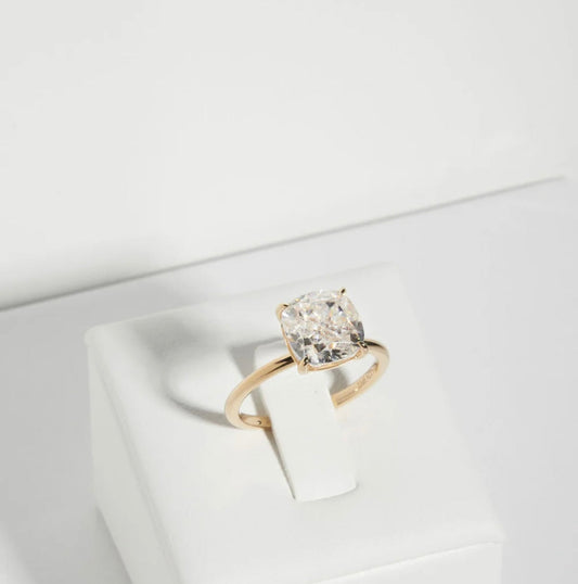 Close-up of Cushion cut lab-grown diamond (G Colour VS2 Clarity) and prong setting on solitaire ring