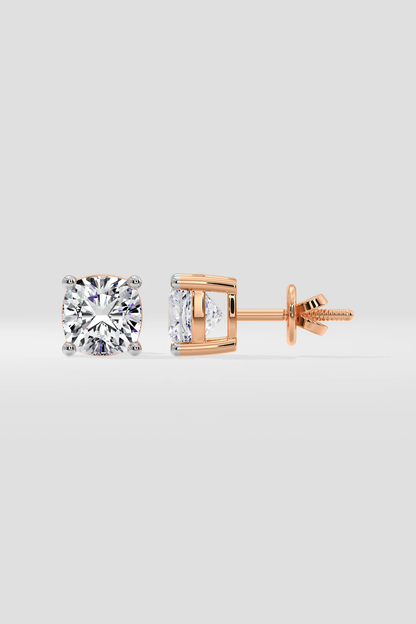 Rose gold diamond stud earrings on a light gray background