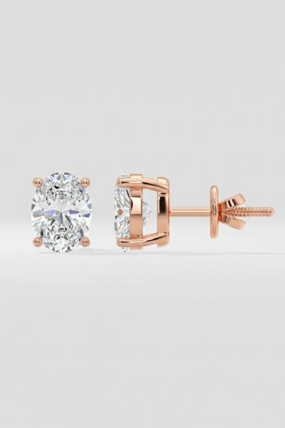 Rose gold diamond stud earrings on a light gray background