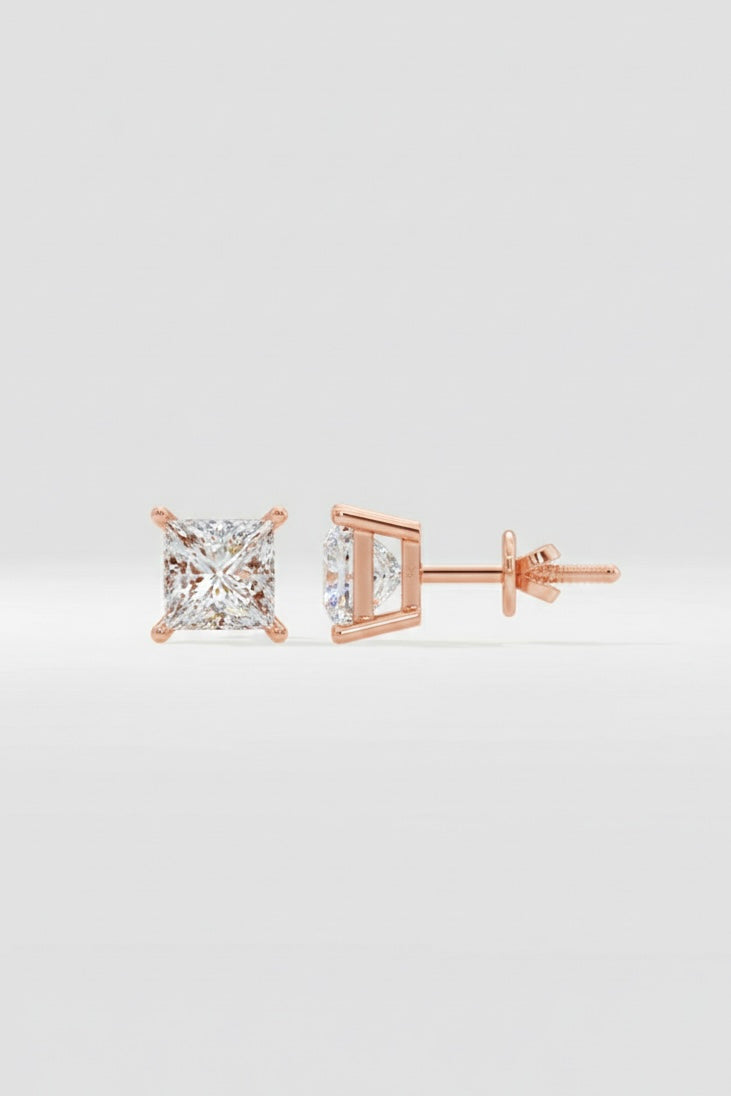 Rose gold diamond stud earrings on a light gray background