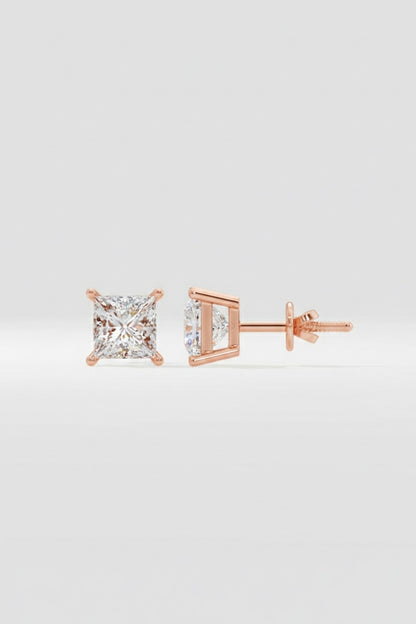 Rose gold diamond stud earrings on a light gray background