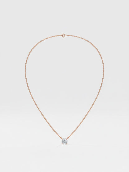 Rose Gold necklace with a round diamond pendant on a light gray background