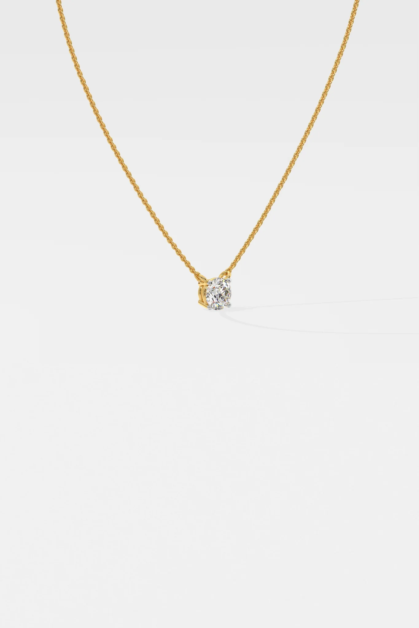 Side profile of custom round solitaire diamond necklace in gold highlighting setting and chain