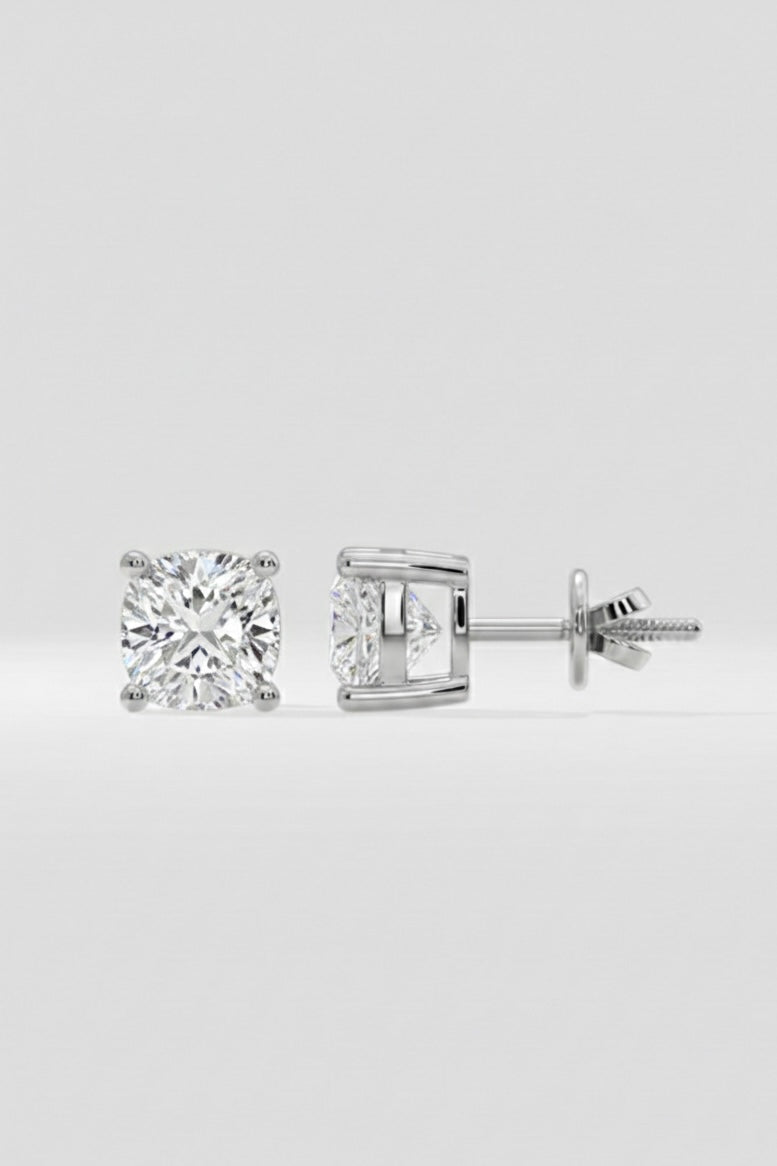 Pair of diamond stud earrings on a light gray background