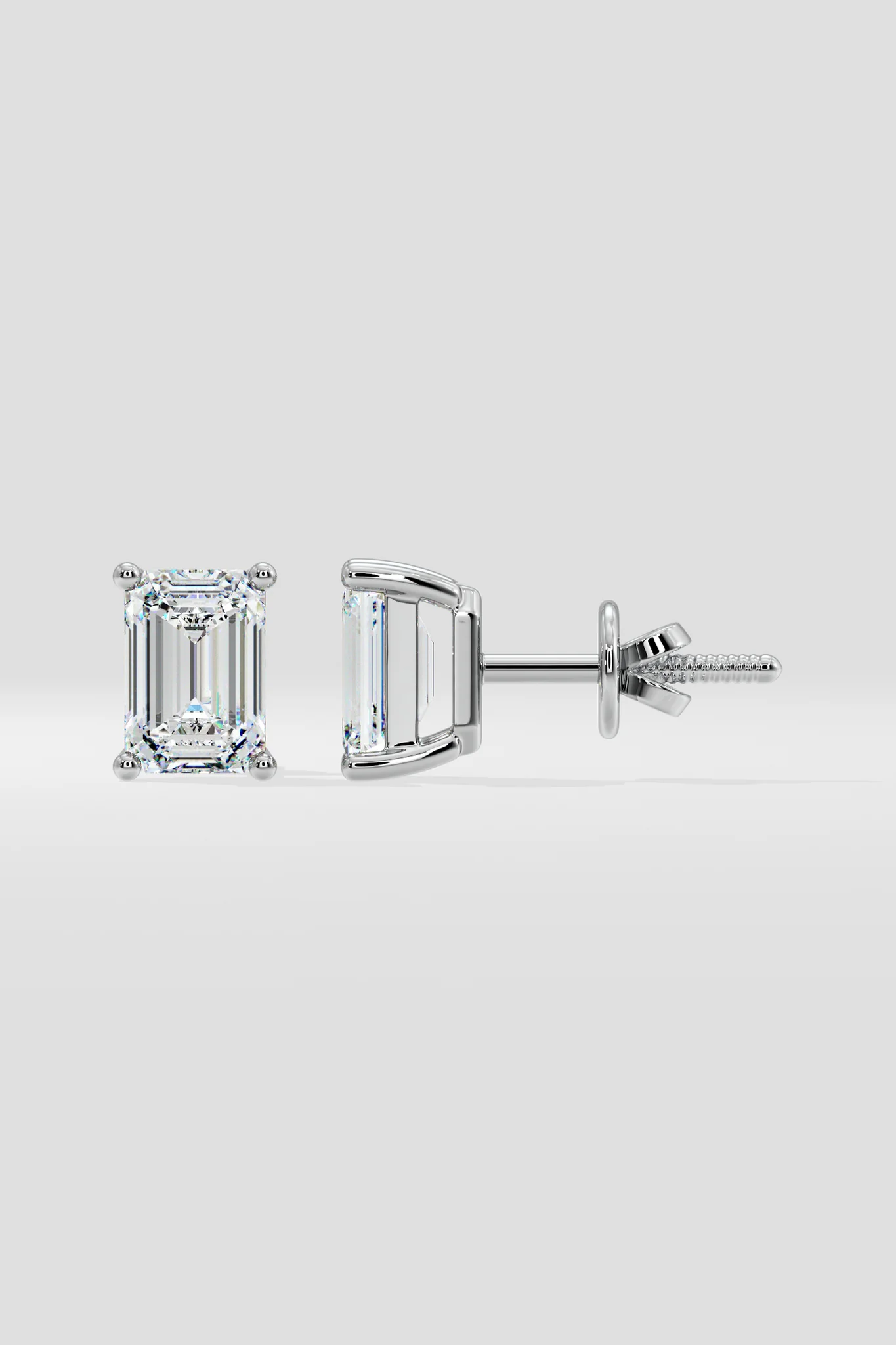 Pair of diamond stud earrings on a light gray background