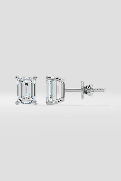 Pair of diamond stud earrings on a light gray background