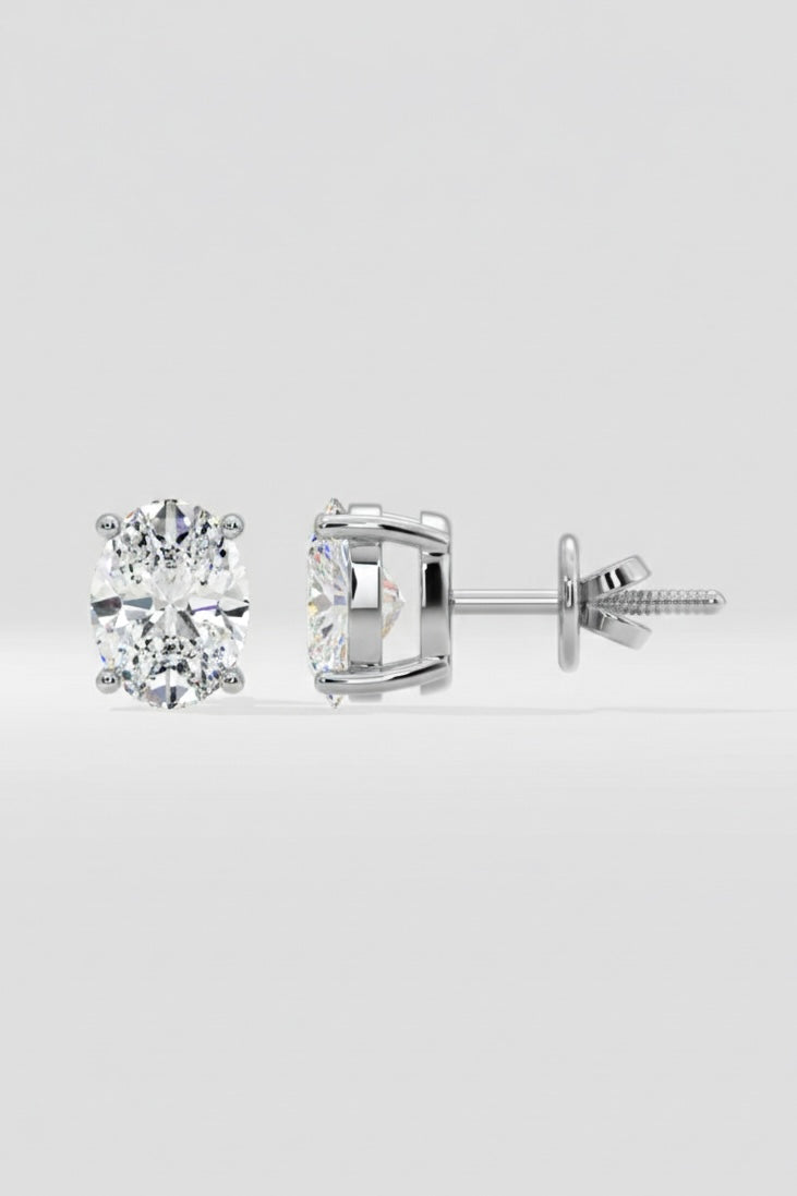 Pair of diamond stud earrings on a light gray background