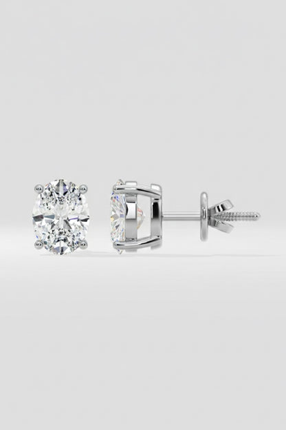 Pair of diamond stud earrings on a light gray background