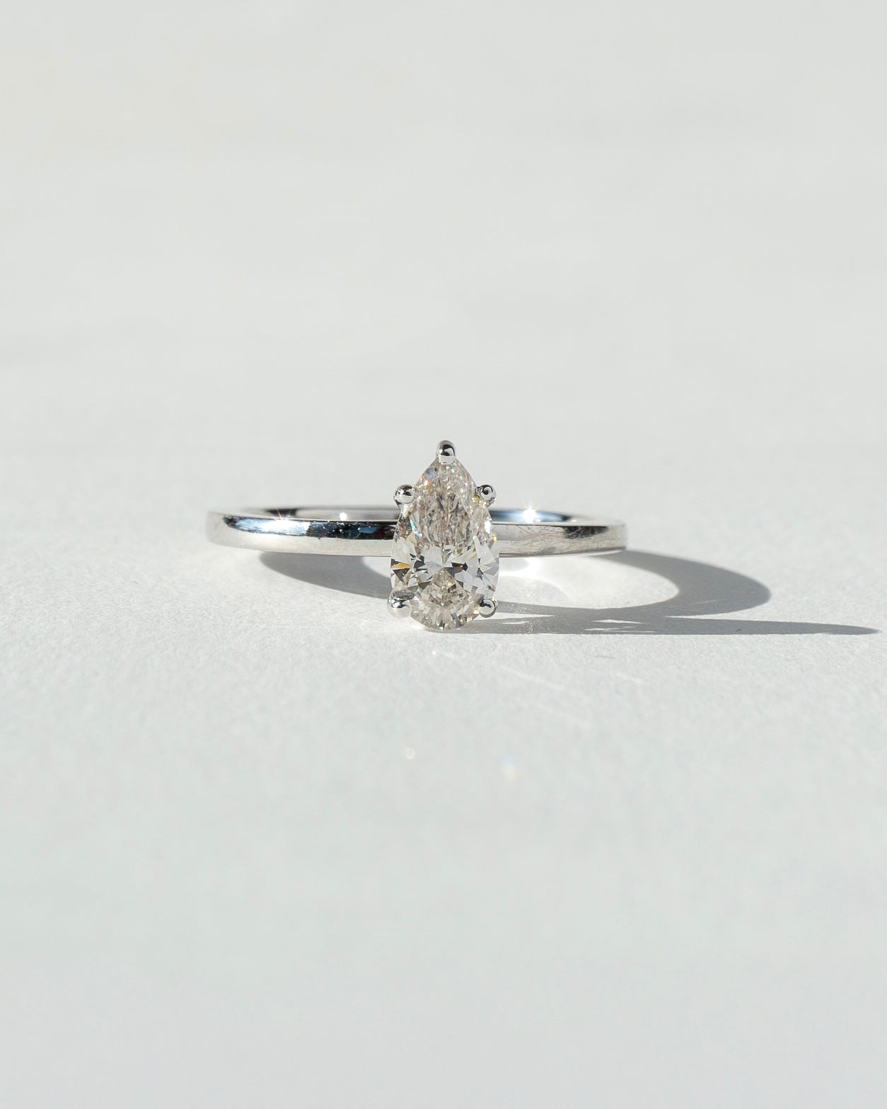 Diamond ring on a light gray background