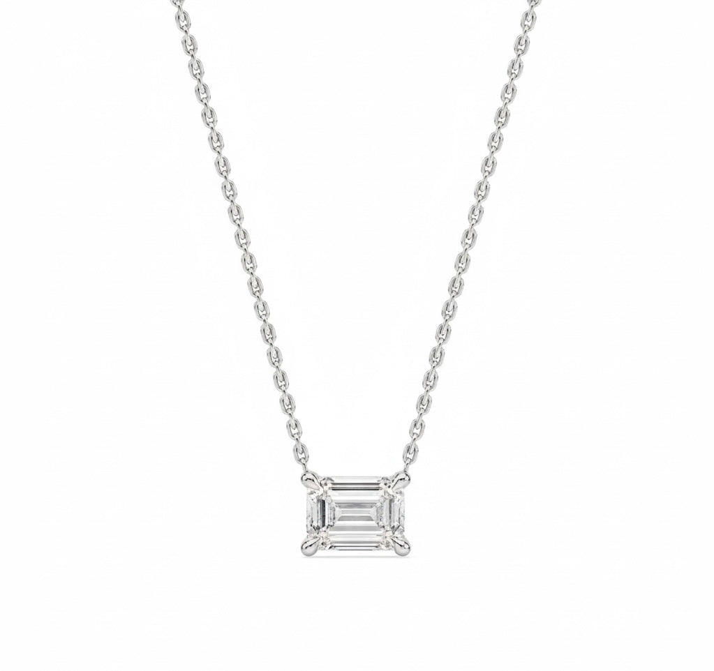 Diamond necklace with emerald-cut pendant on a white background
