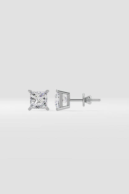 Pair of diamond stud earrings on a light gray background