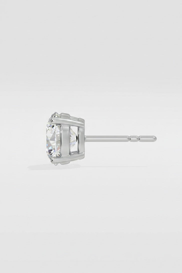 diamond stud earring on a light gray background
