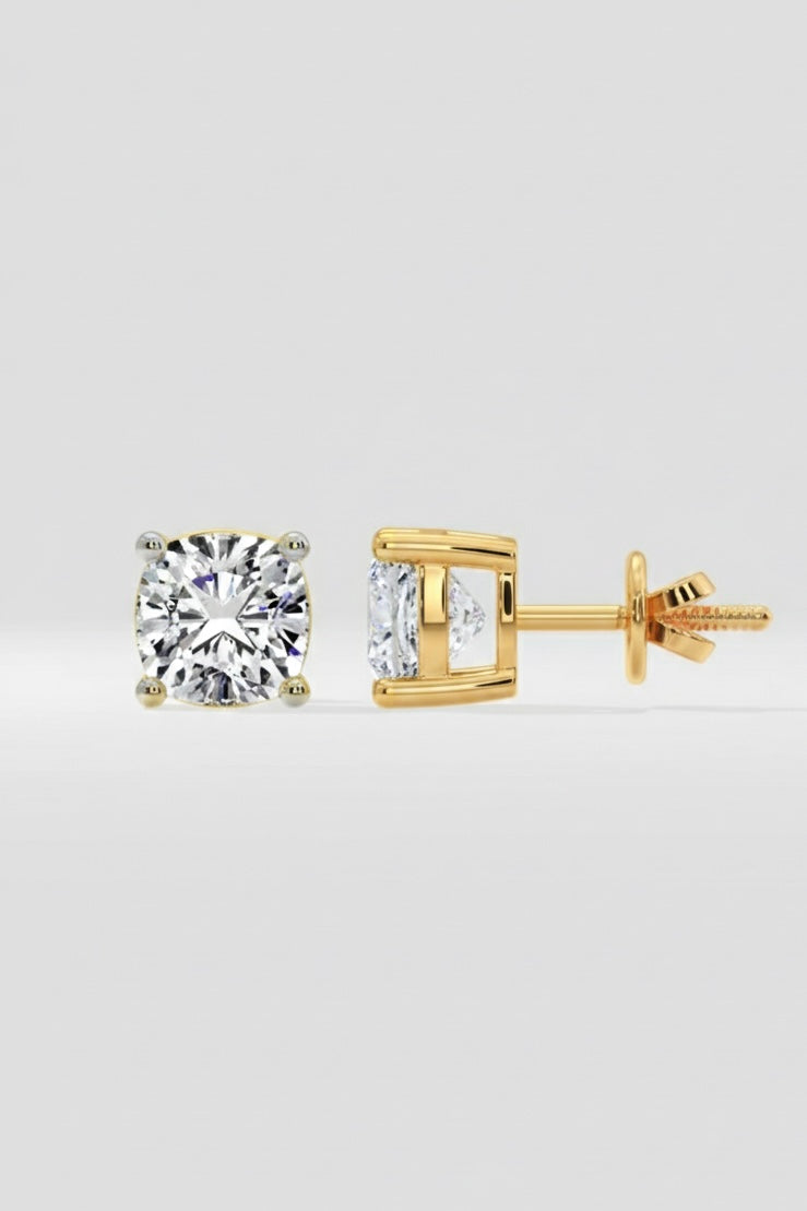 Gold stud earrings with Cushion cut diamond on a light gray background