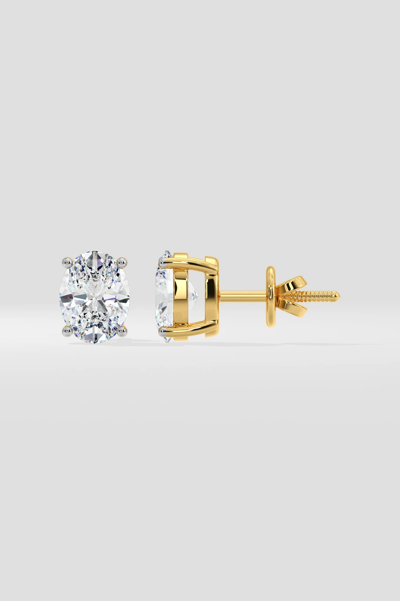 Gold stud earrings on a light gray background