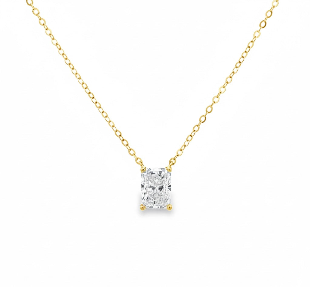 Gold necklace with a diamond pendant on a white background