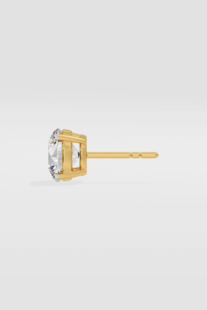 Gold Diamond stud earring on a light gray background